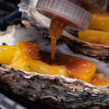 Saucing up our Carlsbad Kraken oysters before the barbeque. 